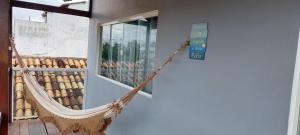 a hammock hanging on the side of a building at Maravilha do Patacho in Pôrto de Pedras