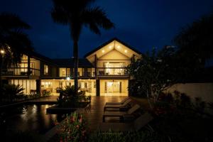 a villa with a pool at night at Naisoso Island Villas - Fiji in Nadi