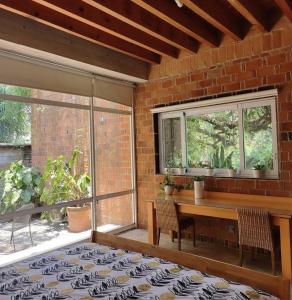 a room with a table and chairs and a brick wall at Casa María de mi Corazón in Tepoztlán +20 photos