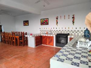 a kitchen with a stove and a counter top at Casa 3 amigas in Troncones