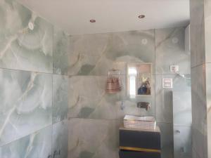 a bathroom with a sink and a mirror at Anayah B and B in Shimla +7 photos