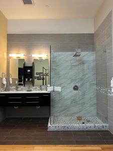 a bathroom with a shower and a mirror at Rio Vista Inn & Suites Santa Cruz in Santa Cruz