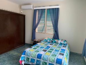 a bedroom with a bed and a window at Hostal primaveras nest centro santa ana in Santa Ana +7 photos
