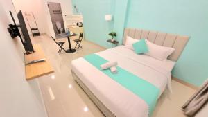 a bedroom with a bed with a teddy bear on it at Go Homey Cemara Asri in Pulauberayan Dadap