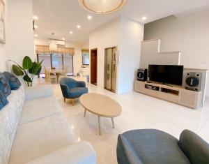 a living room with a couch and a tv at Luxury Apartment - Homestay Newlife Tower in Ha Long