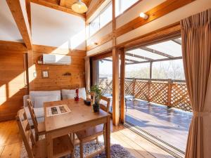 a dining room with a table and a large window at 瀬戸内リゾートベッセルおおち in Higashikagawa
