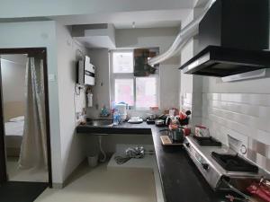 a small kitchen with a sink and a stove at RAGHAV SADAN Luxury Apartment in Prayagraj +2 photos
