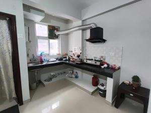 a kitchen with a counter and a sink in it at RAGHAV SADAN Luxury Apartment in Prayagraj