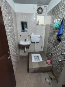 a bathroom with a toilet and a sink at RAGHAV SADAN Luxury Apartment in Prayagraj