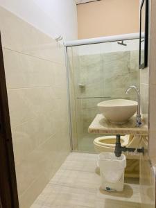 a bathroom with a sink and a glass shower at Hotel San Andrés Mompox Ubicados en el Centro Histórico in Mompos