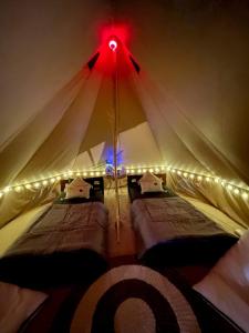 a bedroom with two beds in a tent at Lainkalogos Glamping in Rabia +163 photos
