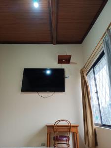 a flat screen tv on a wall in a room at Hostal Your Home in Quito +46 photos