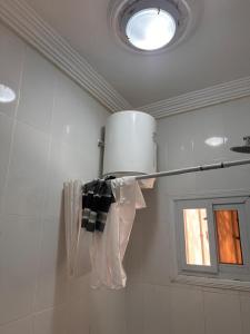 a ceiling light in a bathroom with a window at Muhammed Ceesay Villa in Old Yundum