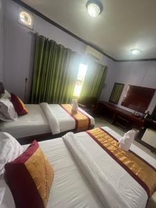 Postel nebo postele na pokoji v ubytování Khampaseuth Hotel