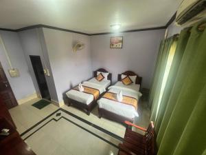 Postel nebo postele na pokoji v ubytování Khampaseuth Hotel