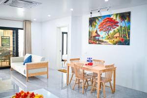 a living room with a table and chairs at JJY Apartment in Nadi
