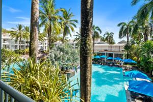 a view of the pool from the balcony of a resort at Private Beach Club Apartment in Building 2 in Palm Cove +1 photo