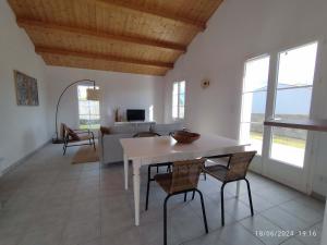 a kitchen and living room with a table and chairs at Maison rénovée Saint-Denis, proche océan, jardin, parking - FR-1-778-43 in Saint-Denis-dʼOléron +6 photos