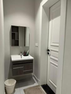 a bathroom with a sink and a toilet and a mirror at شقة حديثة مودرن 3 غرف وصالة a9 in Riyadh