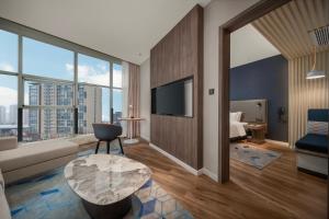 a living room with a couch and a table at Holiday Inn Express Zhengzhou Guancheng by IHG in Zhengzhou