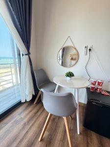 a table and a chair and a mirror in a room at Vile Villa- Homestay 2 Đảo Phú Quý in Cu Lao Thu +117 photos
