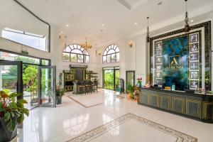 a large room with a lobby with glass doors at Athenia Hoi An Boutique Hotel & Spa in Hoi An