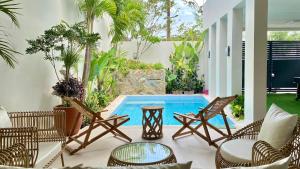 a patio with chairs and a swimming pool at Nazville vacation home in Pasig
