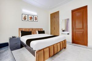 a bedroom with a large bed and a bathroom at 3BHK Luxury Apartment- LOTUS INN in Gurgaon