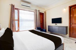 a bedroom with a bed and a large window at 3BHK Luxury Apartment- LOTUS INN in Gurgaon