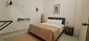 a bedroom with a bed in a room at Ipoh Meru Landed Homestay TropiCasa 28 in Ipoh