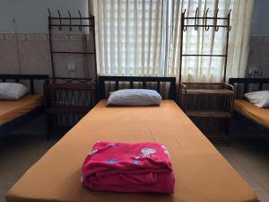 a room with two beds and a blanket at Eco-Home Siem Reap Homestay in Siem Reap +9 photos