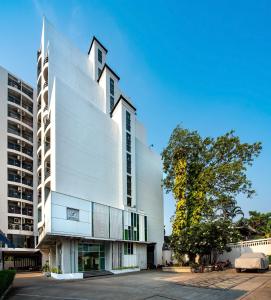 a white building with a tower on top of it at THE Legacy convention hotel in Nonthaburi