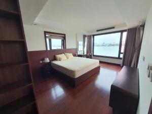 a bedroom with a bed and a large window at Lakeside Retreat - Tay Ho in Hanoi