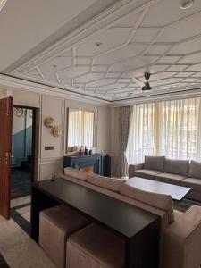 a living room with a couch and a table at 4bhk-Villa at dlf valley township Panchkula in Panchkula