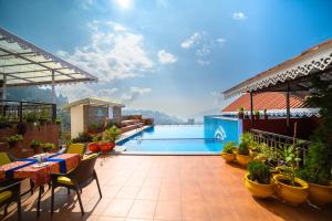 a patio with a swimming pool on top of a building at Sinclairs Gangtok in Gangtok