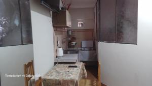 a small kitchen with a table in a room at La Posada de Mary Departamento 1 in Sucre