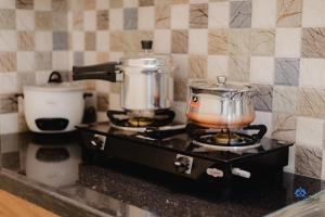 a stove with two pots on top of it at Trip shelters Gachibowli in Hyderabad