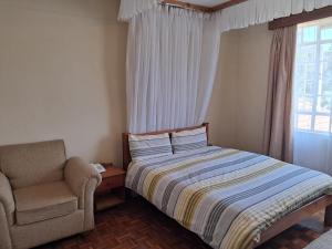 Postel nebo postele na pokoji v ubytování GRACEMONT Guesthouse