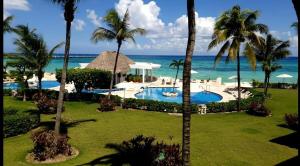 an aerial view of a resort with a pool and the ocean at Condominio Xaman Ha 7107 in Playa del Carmen