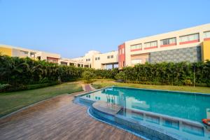 an image of a swimming pool in front of a building at Sinclairs Burdwan in Barddhamān
