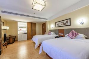 a hotel room with two beds and a television at SSAW Boutique Hotel Hangzhou Qiandao Lake in Chun'an