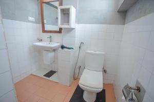 a bathroom with a toilet and a sink at Lucky Seven Hikkaduwa in Hikkaduwa