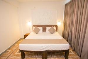 a bedroom with a bed in a room at Lucky Seven Hikkaduwa in Hikkaduwa