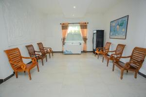 a room with a row of chairs and a refrigerator at Lucky Seven Hikkaduwa in Hikkaduwa