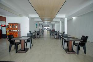 a row of tables and chairs in a room at Lucky Seven Hikkaduwa in Hikkaduwa