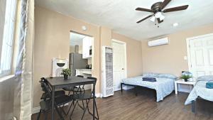 a living room with a table and a bedroom at The Disney Hostel - Santa Ana in Santa Ana +167 photos