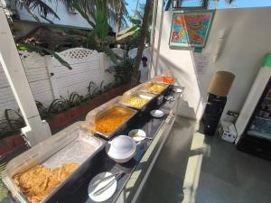 a buffet line with many different types of food at Aqua Beach Rooms, only accommodation on Ashwem Beach in Mandrem