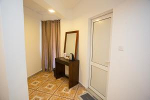 a room with a mirror and a dresser with a mirror at Lucky Seven Hikkaduwa in Hikkaduwa