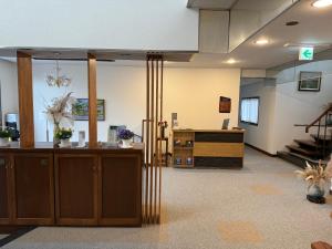 an empty lobby with a reception desk and stairs at Sansui Resorts Yamanakako in Yamanakako