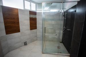 a shower with a glass door in a bathroom at Lucky Seven Hikkaduwa in Hikkaduwa